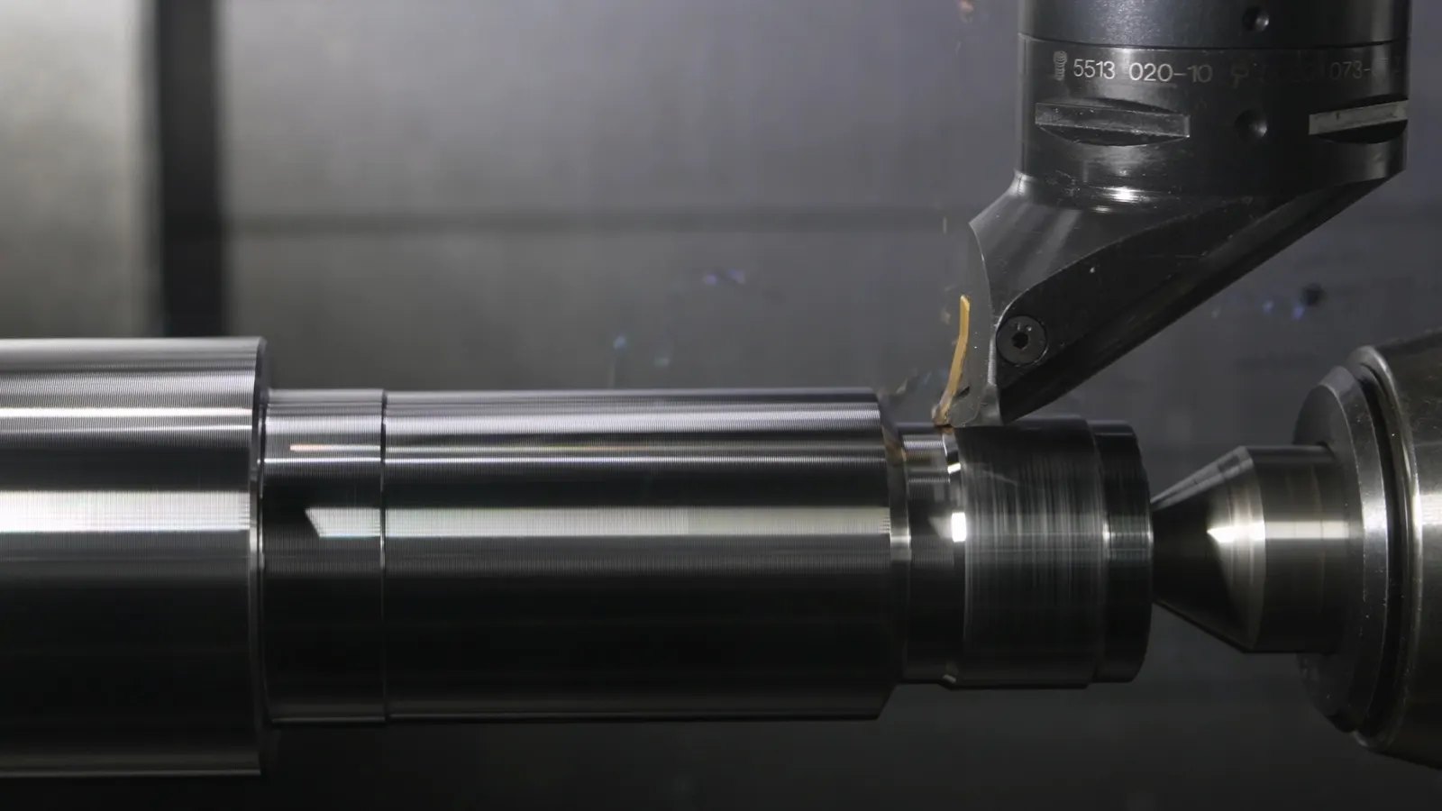Precision CNC turning setup with cylindrical metal parts secured for machining
